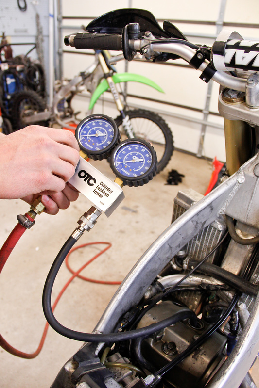 Setting up a leakage tester on the dirt bike